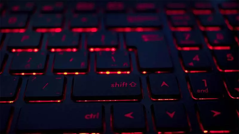A close-up of a dark keyboard with red backlighting, highlighting keys such as Shift, Ctrl, and arrow keys, reminiscent of a vibrant Miami night in Florida.